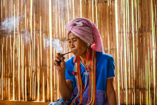 female-karen-hill-tribe-is-smoking-tobacco-pipe_35977-295